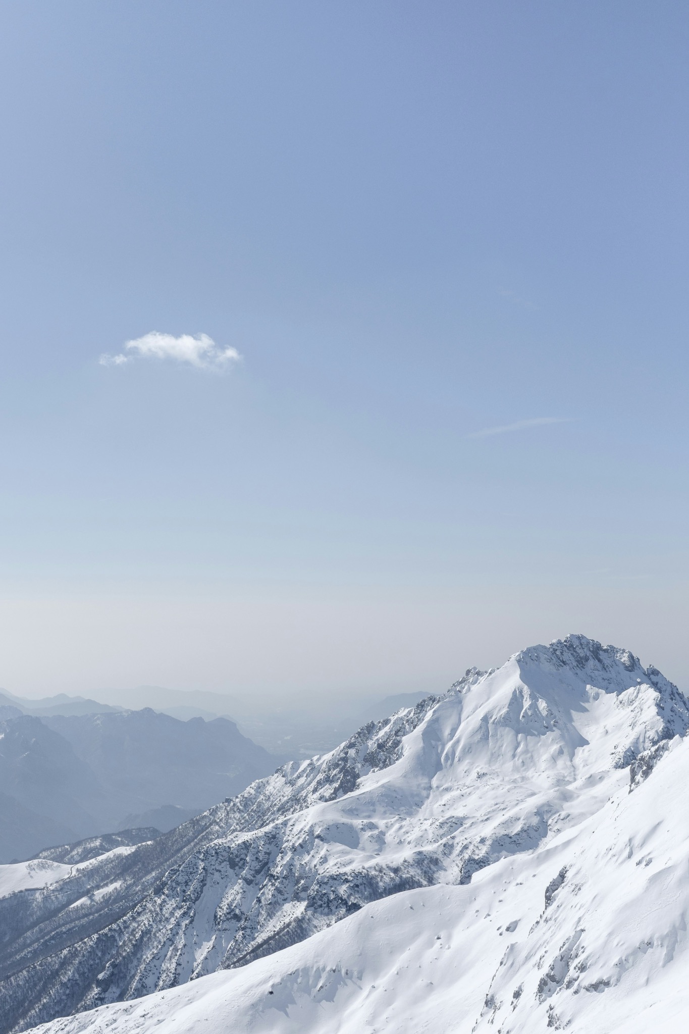 Snow-covered mountain beneath open sky
